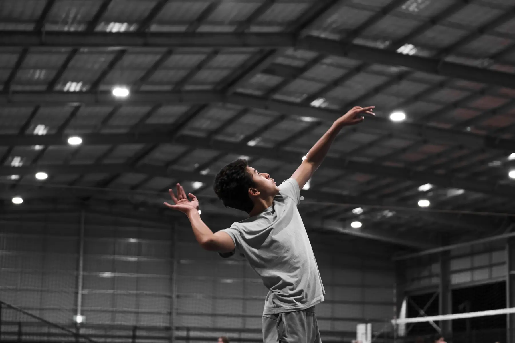 A volleyball participant preparing to serve during a 2026 Sharks Volleyball session