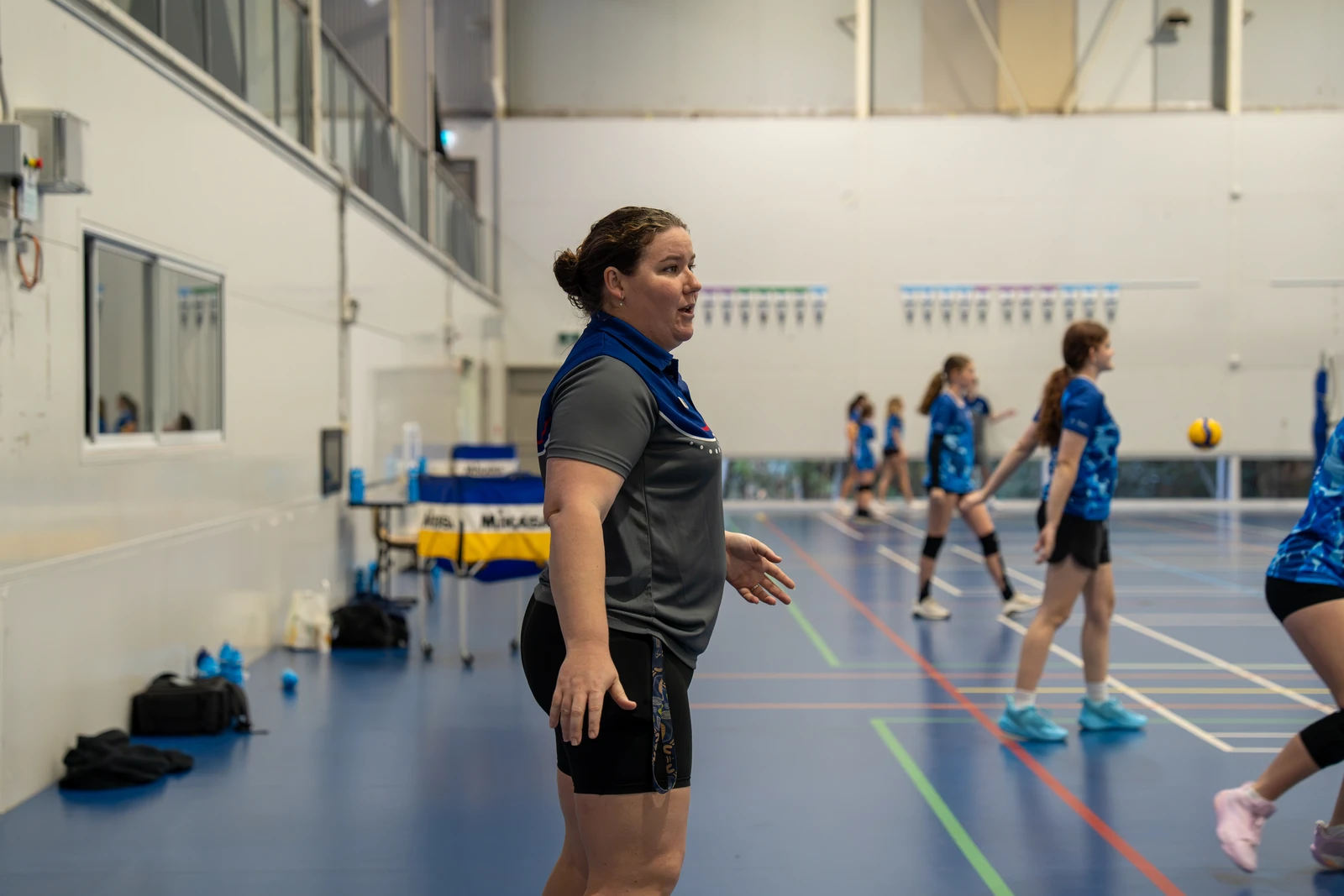 Adult Sharks Volleyball athletes training together on an indoor court