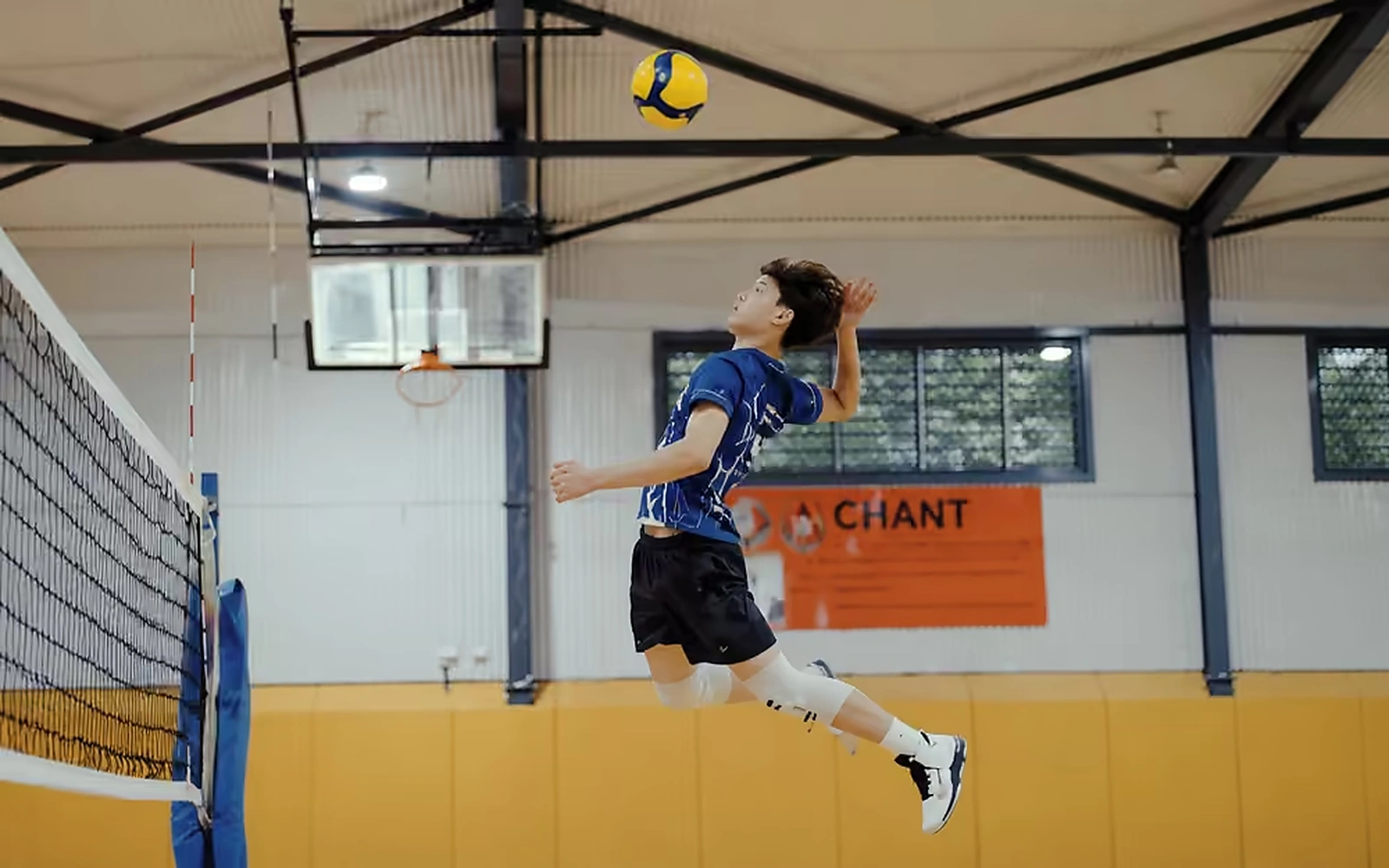 Junae Numata jumping to spike a volleyball during a Sharks Volleyball session