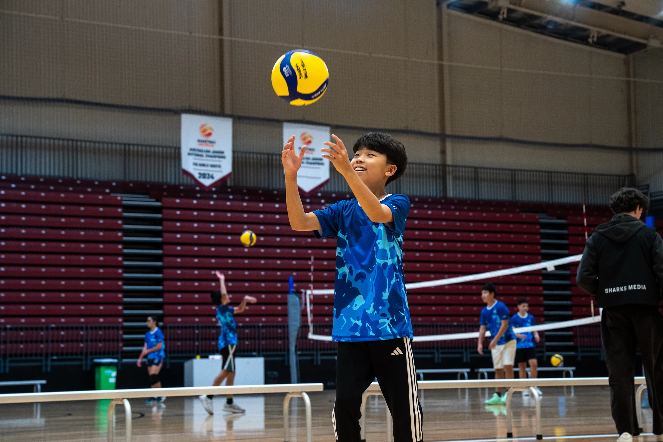 Young Sharks Volleyball camp athlete smiling while practising ball control