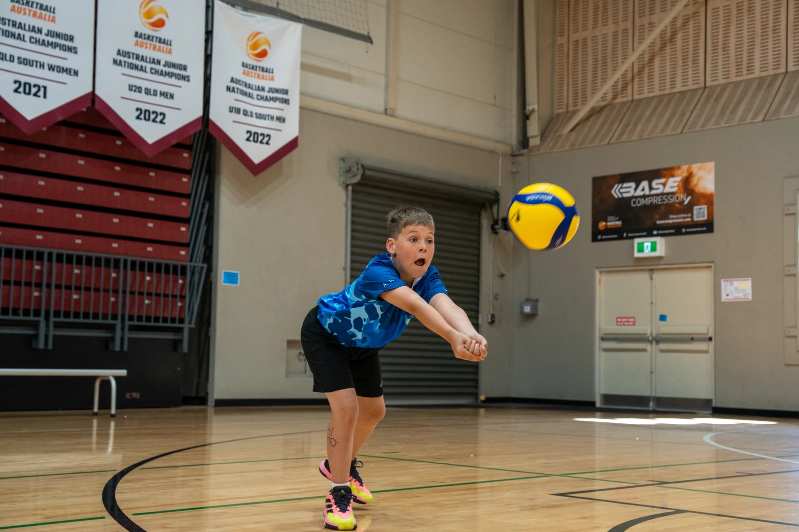Young Sharks Volleyball camp athlete passing a volleyball with focused technique