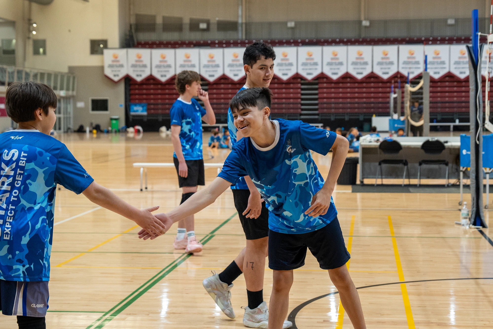 Sharks Camp athletes sharing a high-five during training