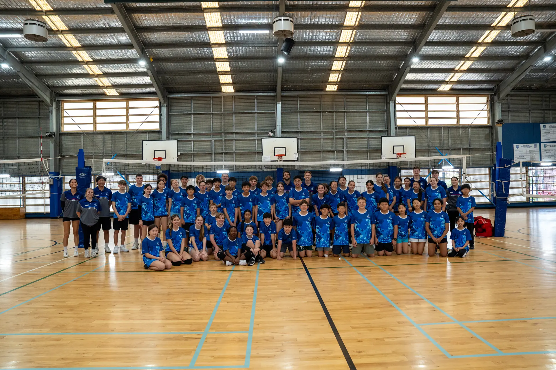 Sharks Volleyball camp athletes and coaches gathered together for a group photo
