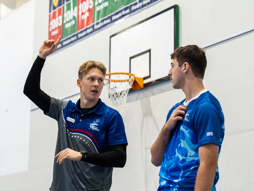 Billy Greber discussing a drill with a Sharks Volleyball athlete