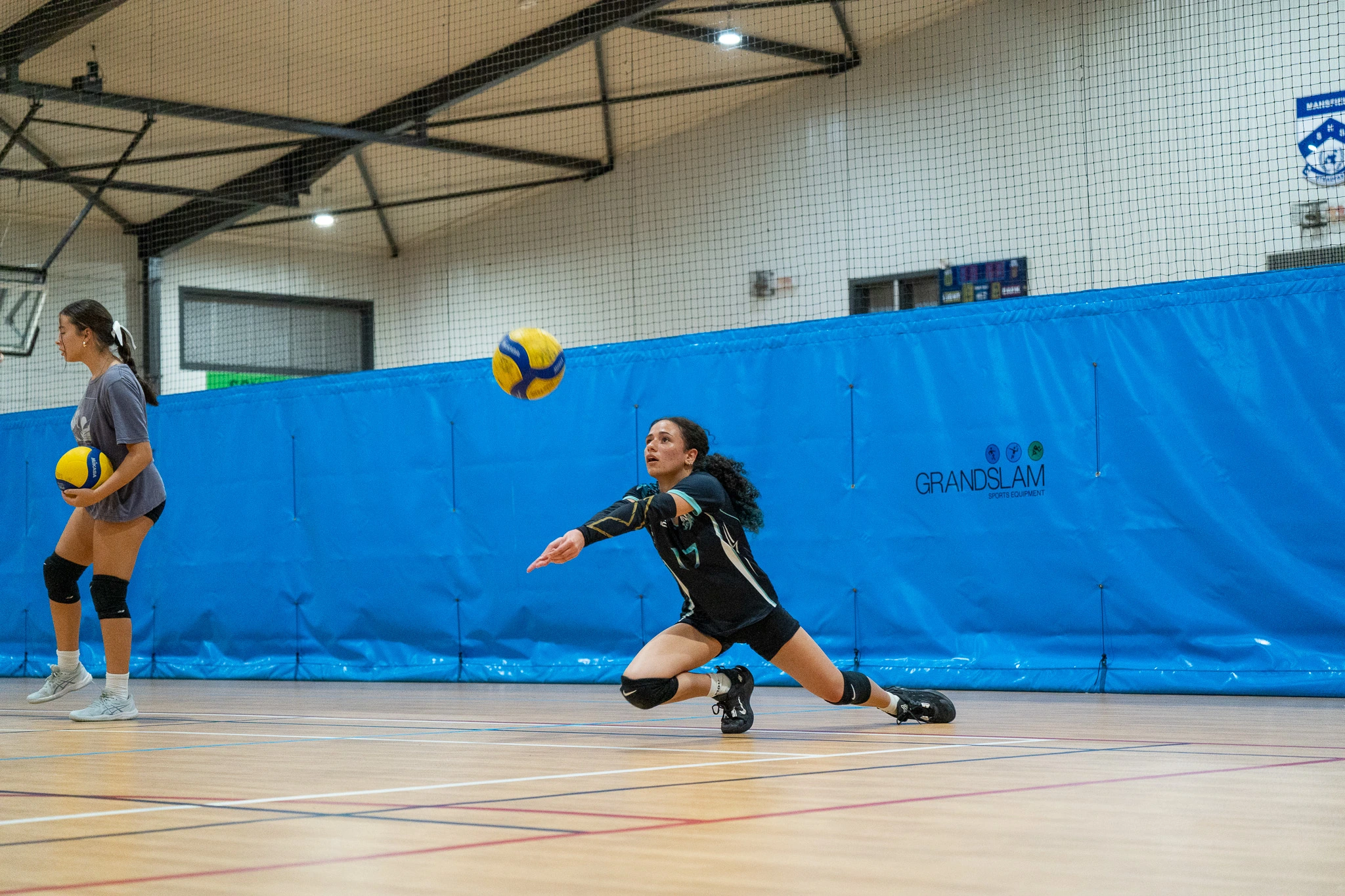 Sharks Volleyball athlete diving to receive the ball during advanced training